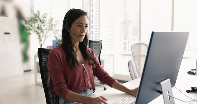 Positive friendly contact support center employee in headset talking to customer on audio call, working at computer monitor, giving technical support, help, assistance to client