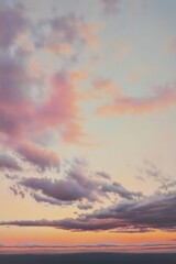 Obraz premium Pastel Sky with Soft Clouds at Sunset or Sunrise in a Serene and Peaceful Landscape View
