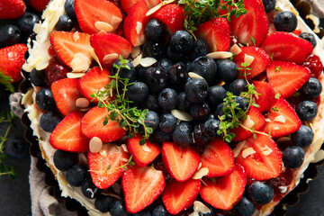 Sweet tart with berries in plate.