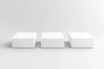 Three blank white cube display stands