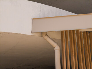 Low angle view of building roof with drain pipes, no people.
