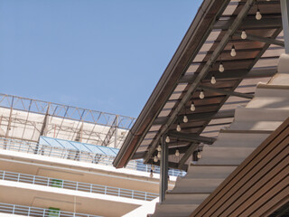 Low angle view, roof corner of shop food with gutters. blurred bg