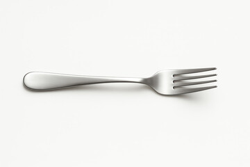 A clean and shiny stainless steel fork lies flat on a white background, showcasing its design and utility. Perfect for culinary presentations and dining aesthetics.