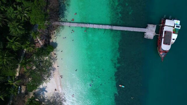 aerial view of Ko Lao Ya Nai island, Thailand, featuring crystal clear turquoise waters and palm trees. Fantastic aerial view flight drone camera pointing down