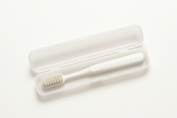 A clean and modern travel toothbrush in a protective case