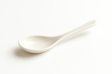 A minimalist view of a white ceramic spoon isolated on a light background. Perfect for culinary-themed projects, cookbook illustrations, or food-related designs.