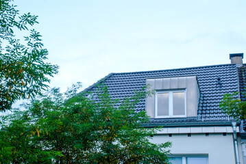 Simplicity and Serenity: A Single Window on a Roof at Twilight