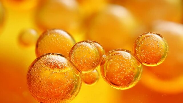 Close-up of vibrant orange bubbles floating in liquid, creating a dynamic abstract background