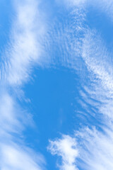 Low angle view of beautiful blue sky with strange shape of fluffy white clouds in the morning or evening in sunny day used as natural background texture in decorative art work