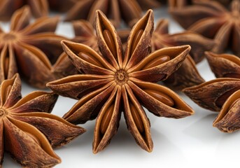 Close up of star anise spice pods on a white surface, food ingredient