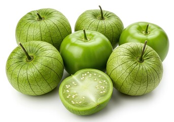 Group of tomatillos with one cut in half showing seeds on a white background