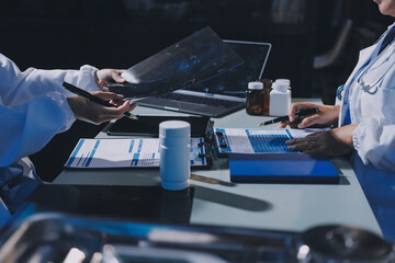 Male and female doctors are having a meeting in a hospital room.