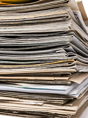 Pile of old paper magazines isolated on white background