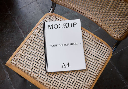 Mockup Of Customizable Spiral Bound Notebook On Chair