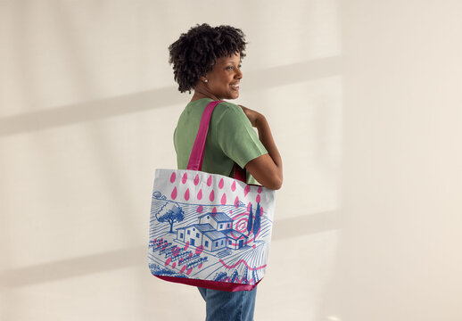 Afro Woman Displays Stylish Tote bag. PSD template mockup ready to use