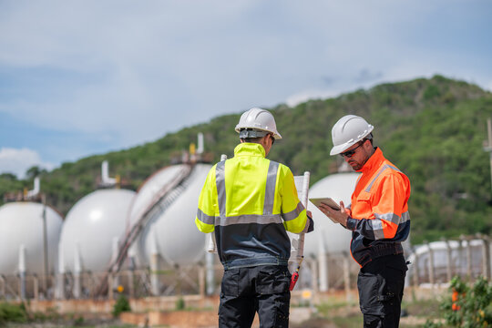 Industrial engineer inspection recording data at gas or petrochemical facility importance of safety, organization, and environmental awareness in industrial settings.
