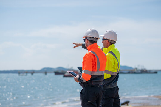 Industrial engineer inspection recording marine transport, offshore facilities energy managing operations while being mindful of sustainability and safety protocols in environmentally sensitive areas.