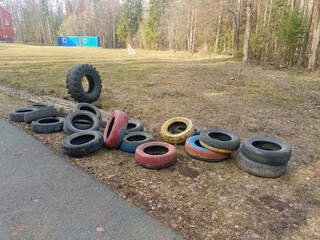 Discarded Colorful Tires in Natural Setting with Grassy Background