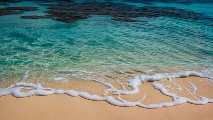 Obraz premium Serene beach scene with clear, turquoise water gently lapping onto the sandy shore.