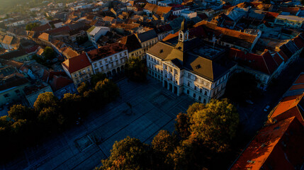Aerial shot of szombathely's historic metropolis square, sport the county hall and red rooftops.
