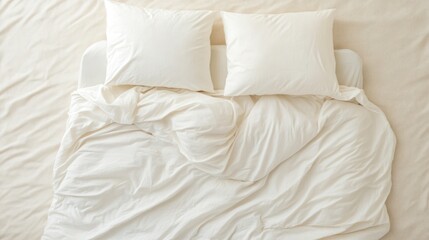 Creamy white bedding unmade bed overhead view minimalist bedroom