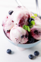Blueberry yogurt ice cream with mint leaves.