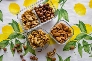 Mix of nuts, walnuts, hazelnuts, almonds in a beautiful glass dish, view from above