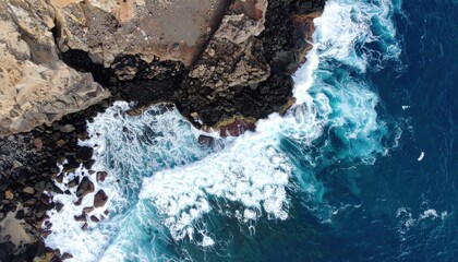 Obraz premium Dynamic ocean waves crash against rugged cliffs coastal landscape aerial view natural beauty serenity