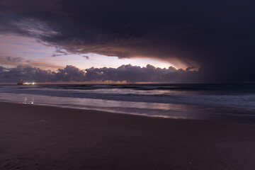 Dramatic Purple Sunrise Over Ocean with Sand Pump Ship
