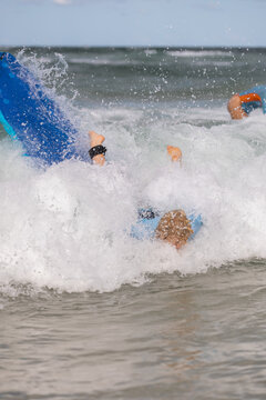 Boy Fall in Waves Learning to Surf