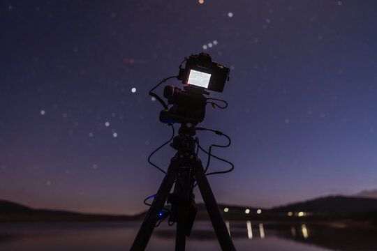 night sky shot ancient city and open space stars satellites camera and cables