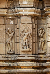 Broken sculpture of a Hindu deity with dancers on Shri Siddheshwara Swamy Temple, Hottal, Nanded, Maharashtra, India.