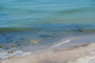 Background image with the sand at the beach and water