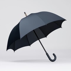 Open black umbrella with curved handle on grey background