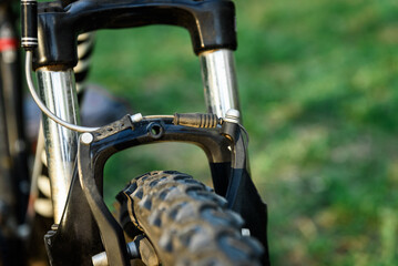 Front v brakes on a bicycle on grass background.