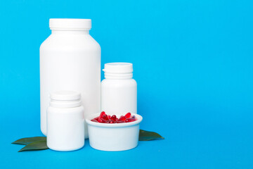 different drugs and health supplement pills with medicine bottle health care and medical top view. Vitamin tablets. Bottle with colored pills on table background. Multivitamins