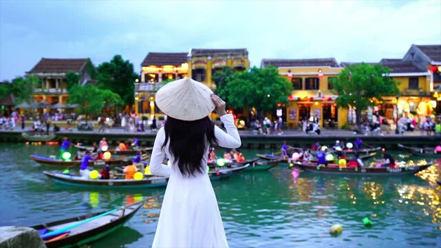 Asian woman wearing vietnam culture traditional at Hoi An ancient town,Hoi an city in Vietnam.