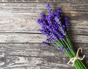 beautiful bouquet of aromatic lavender flowers is elegantly arranged on rustic wooden surface, showcasing vibrant purple hues that evoke sense of calm and tranquility