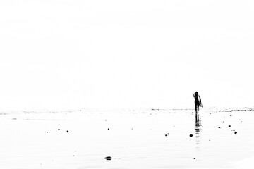 Bali - A female surfer exits the water after a surf