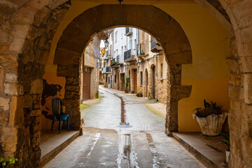 Fototapeta premium Passageway with stone arches under the houses of Rafales, a medieval village in the region of Matarrana, Teruel.