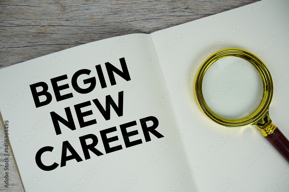 Poster begin new career text message written on paper note with magnifying glass top view on wooden backgro