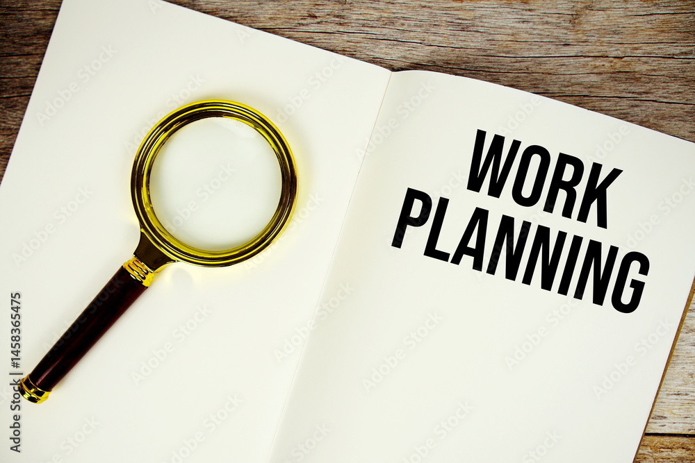 Poster work planning text message written on paper note with magnifying glass top view on wooden background
