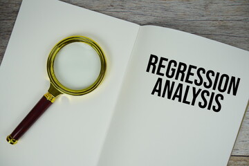 Regression Analysis text written on chalkboard with alarm clock on wooden background