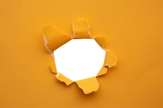 Torn ripped orange paper hole isolated on white background