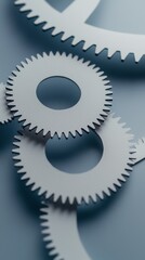 Close-up view of interconnected gears in a mechanical system on a blue surface.