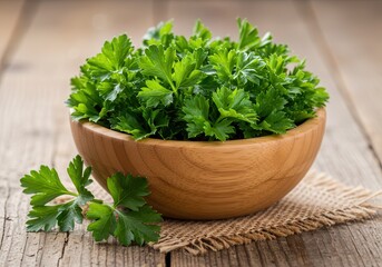 Fresh parsley in a wooden bowl on a burlap cloth and wooden table