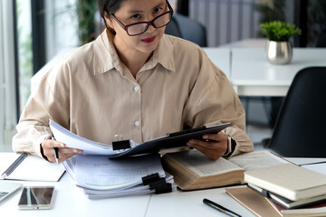 elder businesswoman read her job paper work