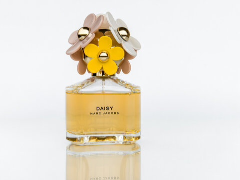 Daisy Marc Jacobs perfume bottle isolated on white background with reflection