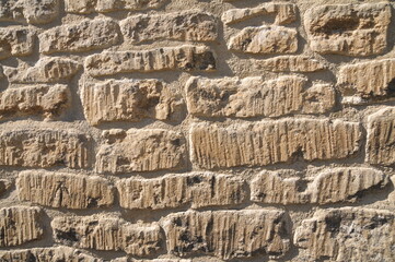 Old stone wall bathed in warm sunlight