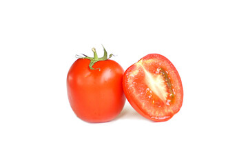 Ripe and halved tomato with detailed view of tomato flesh on white background
